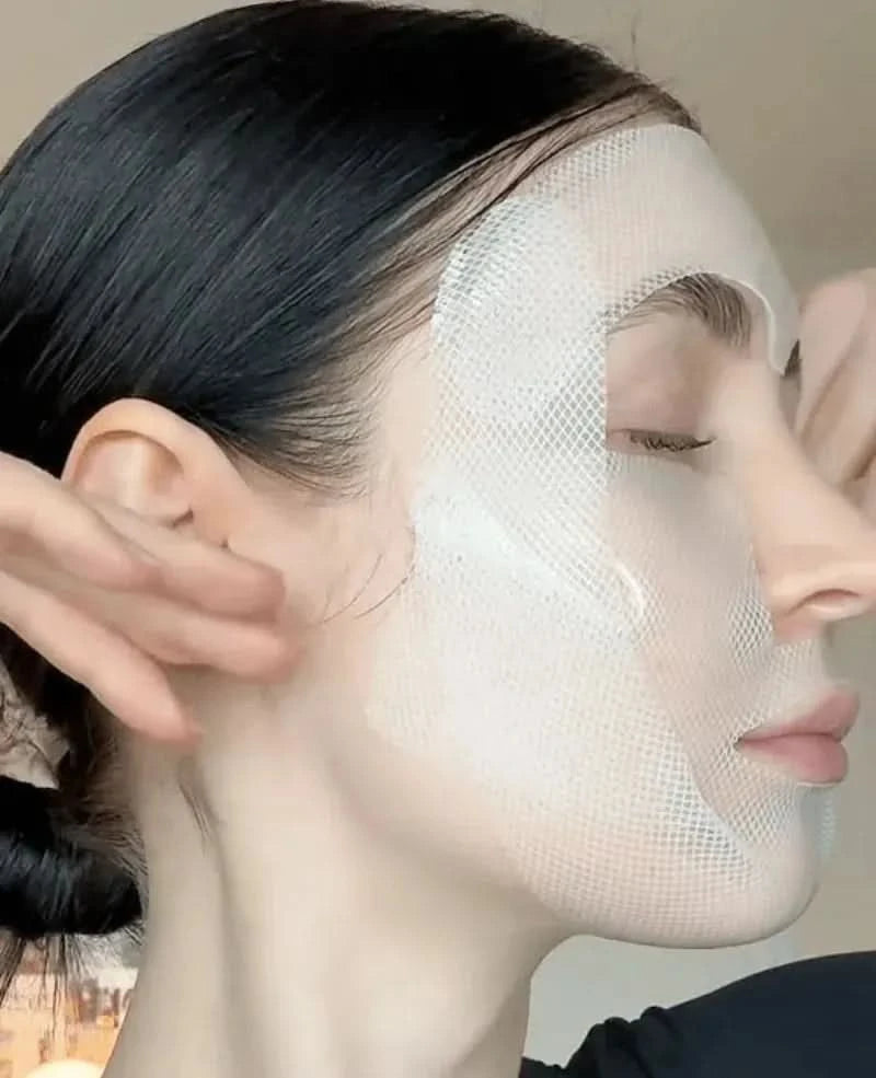 A woman with dark hair wearing a white mesh face mask.